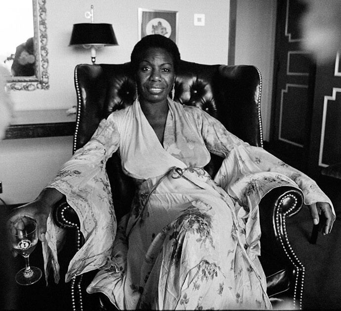 Nina Simone Sitting in Chair smiling